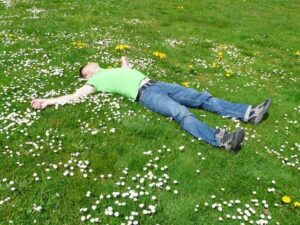 Man relaxing and lying in the grass